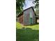 Weathered barn featuring a unique turquoise door, set on a well-maintained green lawn, adding a touch of character at 233 Hicks Rd, Statesville, NC 28625