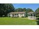 Charming single-story home featuring a covered porch, well-manicured lawn, and a quaint gazebo at 233 Hicks Rd, Statesville, NC 28625
