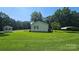 Picturesque side view of a home featuring a lush lawn, gazebo, and covered carport area at 233 Hicks Rd, Statesville, NC 28625