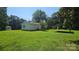 Well-maintained home featuring verdant lawn, carport, gazebo, and back deck at 233 Hicks Rd, Statesville, NC 28625