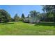 Cozy home with vinyl siding, back deck, and a car port in a lush green yard at 233 Hicks Rd, Statesville, NC 28625