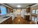 Classic kitchen featuring wood cabinets, white appliances, and hardwood floors at 233 Hicks Rd, Statesville, NC 28625