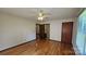 Bright main bedroom with hardwood floors, neutral walls, and view to attached bathroom at 233 Hicks Rd, Statesville, NC 28625