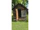 A wooden outbuilding with an open door, perfect for storage, nestled on a well-maintained green lawn at 233 Hicks Rd, Statesville, NC 28625