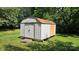 Metal outbuilding offers a secure storage, complemented by a green lawn and shaded by surrounding trees at 233 Hicks Rd, Statesville, NC 28625