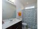 Bright bathroom with a modern vanity, toilet, and decorative shower curtain at 2407 Baxter Se Pl, Concord, NC 28025