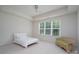 Bright bedroom with a large window, neutral decor, a cozy wicker chair and a simple bed at 2407 Baxter Se Pl, Concord, NC 28025