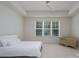 Bright and airy bedroom showcasing neutral decor and a window view at 2407 Baxter Se Pl, Concord, NC 28025