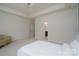 A spacious bedroom features a ceiling fan, neutral carpet, and a connecting bathroom and closet at 2407 Baxter Se Pl, Concord, NC 28025