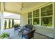 Relaxing covered patio with wicker furniture, a ceiling fan, and views of the serene backyard landscape at 2407 Baxter Se Pl, Concord, NC 28025