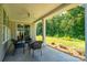 Outdoor patio with elegant wicker seating and views of the lush, green backyard showcasing natural landscaping at 2407 Baxter Se Pl, Concord, NC 28025