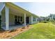 Inviting covered patio with an outdoor seating area and manicured garden beds enhancing the home's outdoor appeal at 2407 Baxter Se Pl, Concord, NC 28025