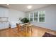 Sunlit dining area featuring hardwood floors, a large window, and a table with seating for two at 2407 Baxter Se Pl, Concord, NC 28025