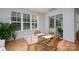Bright dining area features hardwood floors, glass table, seating for two, and a sliding glass door at 2407 Baxter Se Pl, Concord, NC 28025