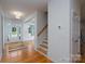 Bright entryway features hardwood floors, white walls, and staircase access to upper level at 2407 Baxter Se Pl, Concord, NC 28025