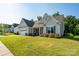 Charming single-story home featuring a well-manicured lawn, attached garage, and inviting curb appeal at 2407 Baxter Se Pl, Concord, NC 28025