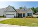 Charming single-Gathering home with a manicured lawn, inviting entrance, and attached two car garage at 2407 Baxter Se Pl, Concord, NC 28025