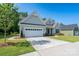 Attractive home featuring a two-car garage, well-maintained lawn, and concrete driveway at 2407 Baxter Se Pl, Concord, NC 28025