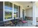 Inviting front porch with stone accents, neutral siding and a glimpse of neighborhood views at 2407 Baxter Se Pl, Concord, NC 28025