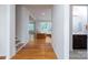 Open-concept hallway featuring hardwood floors that leads to a living room and bathroom at 2407 Baxter Se Pl, Concord, NC 28025