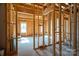 Spacious new construction showcasing the interior framing with natural light from bright windows at 2407 Baxter Se Pl, Concord, NC 28025