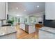 Open-concept kitchen with stainless appliances, granite countertops, and adjoining living and dining areas at 2407 Baxter Se Pl, Concord, NC 28025