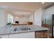 Modern kitchen features granite countertops, stainless steel appliances, and an open view to the living room at 2407 Baxter Se Pl, Concord, NC 28025