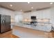 Kitchen island features granite countertops, stainless steel appliances, and ample cabinet space at 2407 Baxter Se Pl, Concord, NC 28025