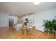 Open-concept kitchen and dining area featuring stainless steel appliances and hardwood floors at 2407 Baxter Se Pl, Concord, NC 28025