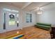 Bright living room featuring hardwood floors and modern green furniture next to a large front door at 2407 Baxter Se Pl, Concord, NC 28025