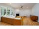 Bright living room featuring a fireplace, a ceiling fan, hardwood floors, and a large window at 2407 Baxter Se Pl, Concord, NC 28025