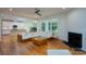 Spacious living room seamlessly connecting to a well-equipped kitchen with stainless steel appliances at 2407 Baxter Se Pl, Concord, NC 28025