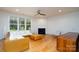 Bright living room featuring a fireplace, a ceiling fan, hardwood floors, and a large window at 2407 Baxter Se Pl, Concord, NC 28025