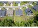Aerial view of a home showcasing its well-manicured lawn, deck, and proximity to nearby houses at 252 Broadleaf Dr, Denver, NC 28037