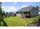 Expansive backyard with a well-maintained lawn and covered deck, ideal for outdoor enjoyment at 252 Broadleaf Dr, Denver, NC 28037