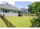 Lush backyard featuring a manicured lawn, black metal fencing, and landscaping that adds to the charm at 252 Broadleaf Dr, Denver, NC 28037