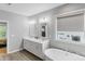 Elegant bathroom with double sinks, a soaking tub, and a window for natural light and privacy at 252 Broadleaf Dr, Denver, NC 28037