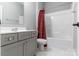 Well-lit bathroom with vanity, modern faucet, and shower/tub combo with patterned shower curtain at 252 Broadleaf Dr, Denver, NC 28037