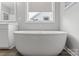 Bright bathroom featuring a standalone tub, stylish fixtures, and natural light from a window at 252 Broadleaf Dr, Denver, NC 28037