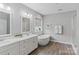 Bright bathroom featuring double vanities, a standalone tub, and a separate shower with modern finishes at 252 Broadleaf Dr, Denver, NC 28037