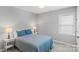 Cozy bedroom with patterned quilt, bedside lamps, and soft carpeting at 252 Broadleaf Dr, Denver, NC 28037