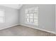 Bright bedroom with large window and plush carpeting providing a soothing neutral palette at 252 Broadleaf Dr, Denver, NC 28037