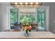Cozy dining area with table and chairs set in front of open sliding doors leading to an outdoor patio at 252 Broadleaf Dr, Denver, NC 28037
