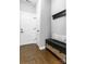 Inviting entryway featuring hardwood floors, a storage bench, and coat rack for organization and style at 252 Broadleaf Dr, Denver, NC 28037