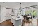 Spacious white kitchen and dining area with stainless steel appliances and access to the outdoor deck at 252 Broadleaf Dr, Denver, NC 28037