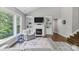Comfortable living room with a fireplace, built-in bookshelves, and a large window view at 252 Broadleaf Dr, Denver, NC 28037
