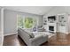 Bright living room with a cozy fireplace, large picture window, and stylish, comfortable furnishings at 252 Broadleaf Dr, Denver, NC 28037