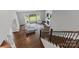 Bright living room featuring hardwood floors, large windows, and a cozy fireplace at 252 Broadleaf Dr, Denver, NC 28037