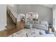 Spacious open-concept living room with a staircase, fireplace, and easy flow to kitchen and dining areas at 252 Broadleaf Dr, Denver, NC 28037