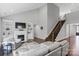 Inviting living room featuring a fireplace, built-ins, soaring ceilings, and an elegant staircase at 252 Broadleaf Dr, Denver, NC 28037